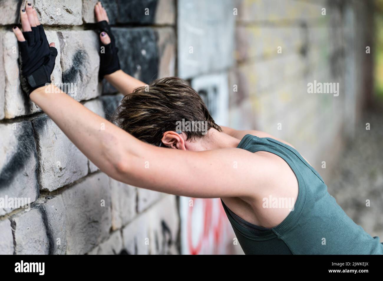 Ritratto di una donna stanca bianca di 36 anni, che si stende contro un muro dopo un lavoro, Bruxelles, Belgio Foto Stock