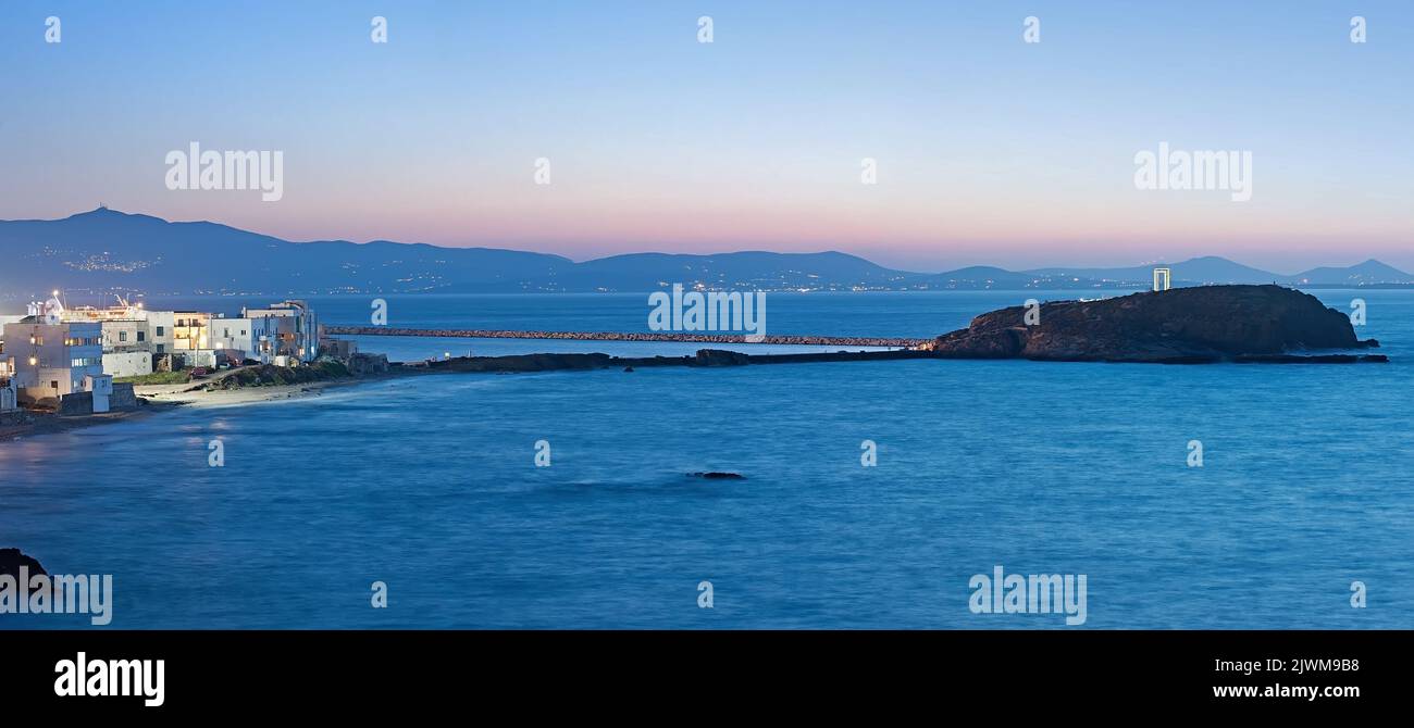 Il panorama notturno della strada sopraelevata dall'isola di Naxos all'isolotto di Palatia con la Portara (la Grande porta) in Grecia Foto Stock