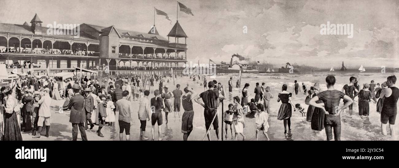 Una scena di bagno di Domenica mattina sulla spiaggia di Coney Island, che mostra il New Iron Pier Landing dei piroscafi di ferro Foto Stock