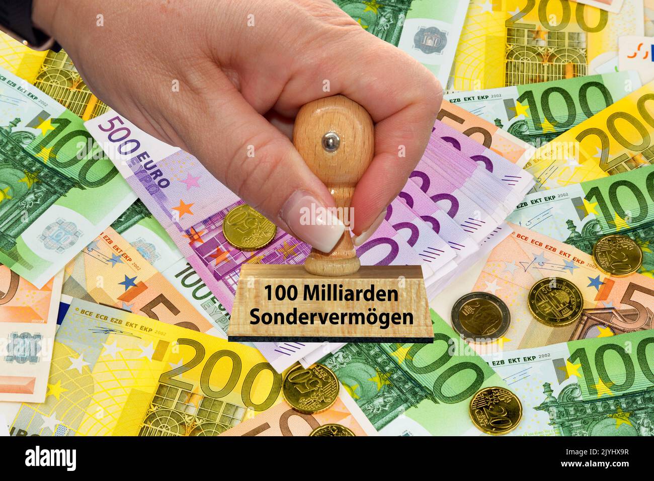 Mano della donna con la scritta del bollo 100 miliardi Sondervermoegen, 100 bene speciale, Euro sullo sfondo, Germania Foto Stock