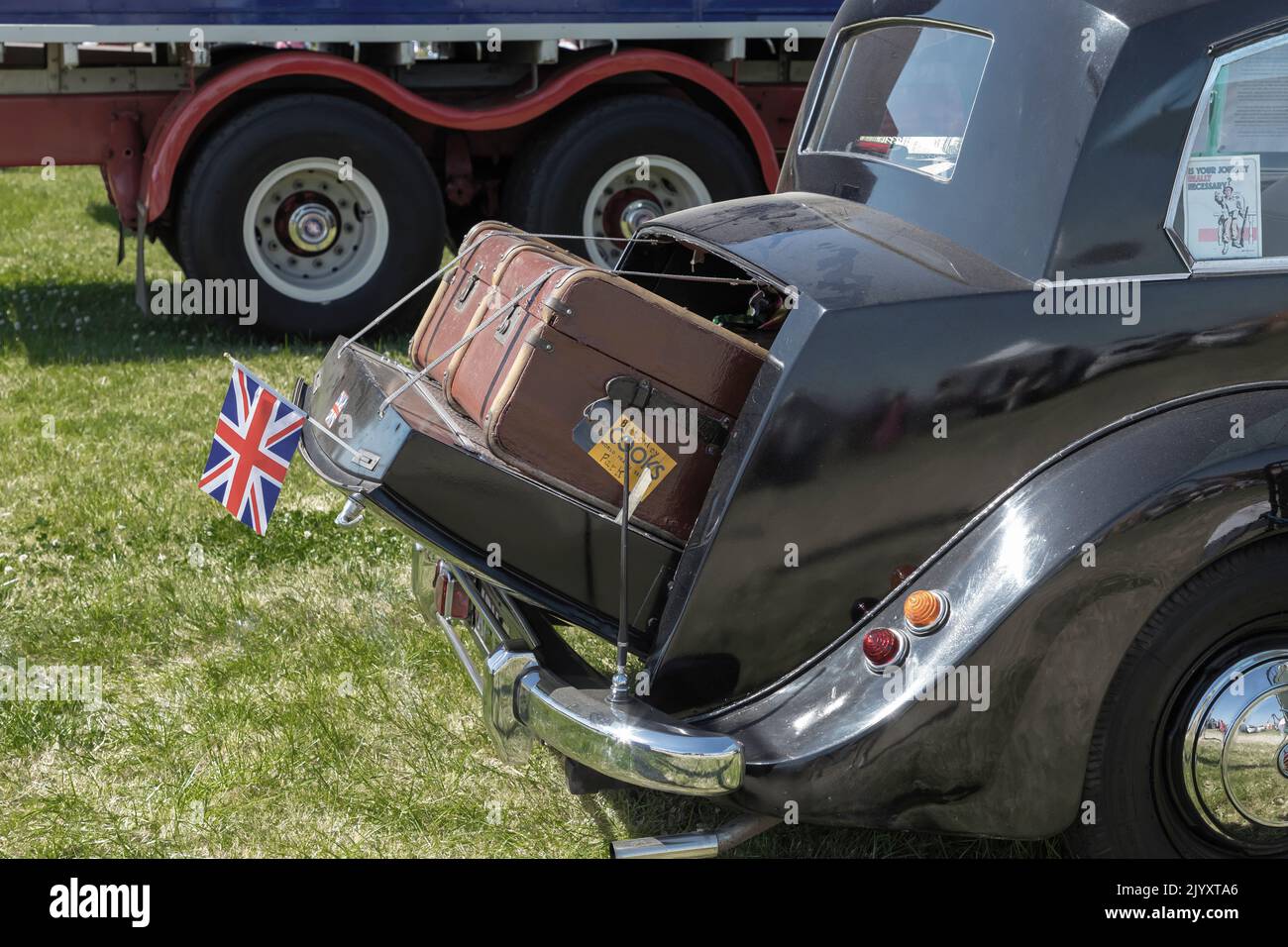 Tabley, Knutsford, Cheshire, UK - Giugno 22nd 2022 - il tronco aperto di una vecchia auto con valigie trasportate e una bandiera Union Jack Foto Stock