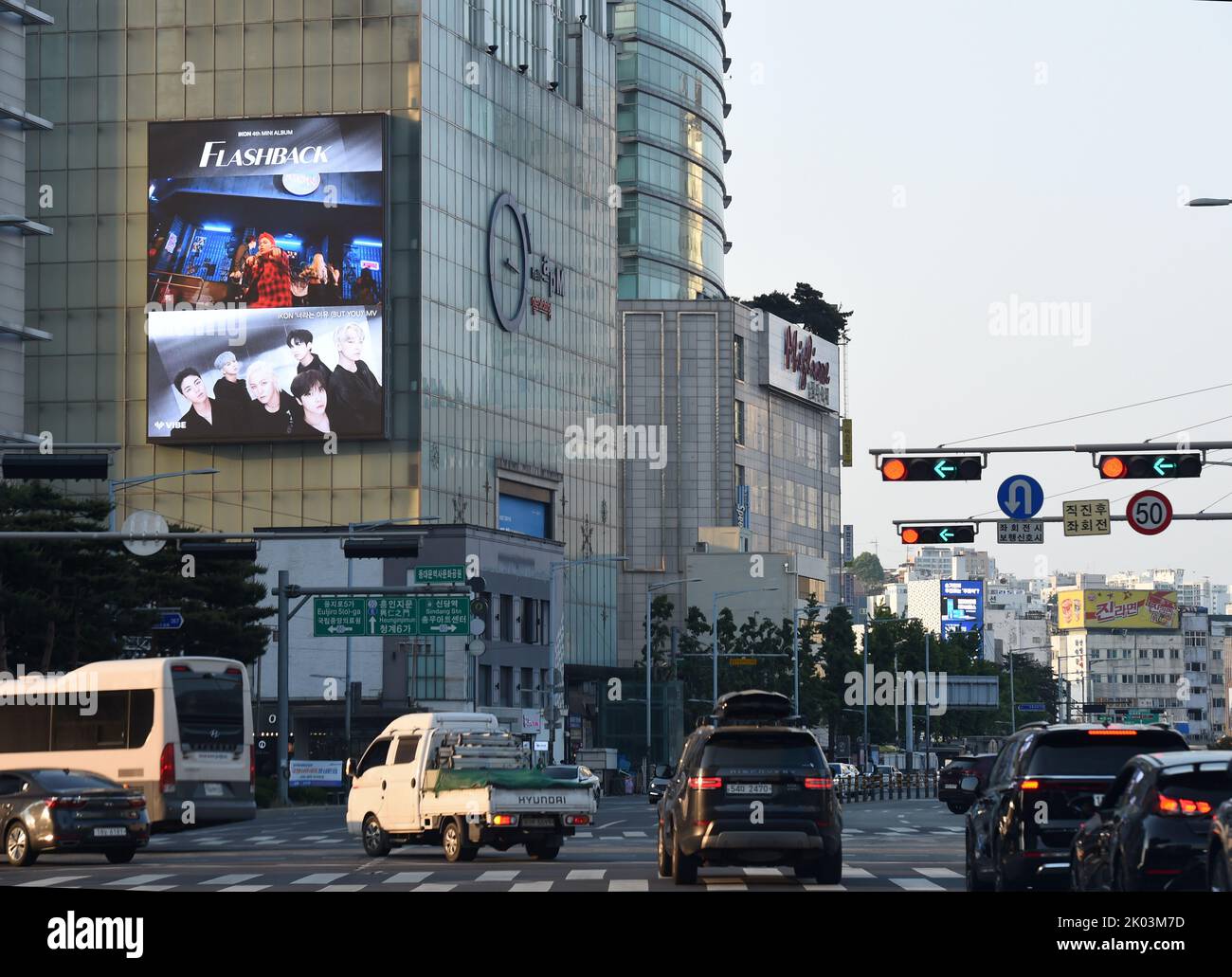 Pubblicità per K-Pop boyband IKON sopra un incrocio trafficato nel centro di Seoul, Corea del Sud Foto Stock