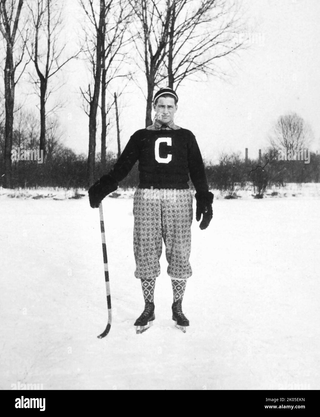Un giocatore di hockey alla moda è pronto per una partita sul ghiaccio nel New England, ca. 1925. Foto Stock