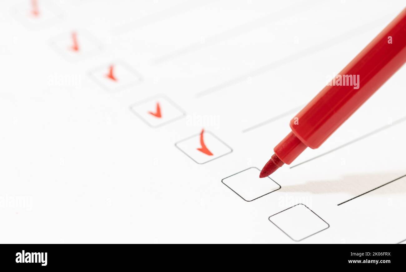 Marcatore rosso con marcatori sul foglio dell'elenco di controllo. Checklist completamento del concetto di attività. Spazio di copia Foto Stock