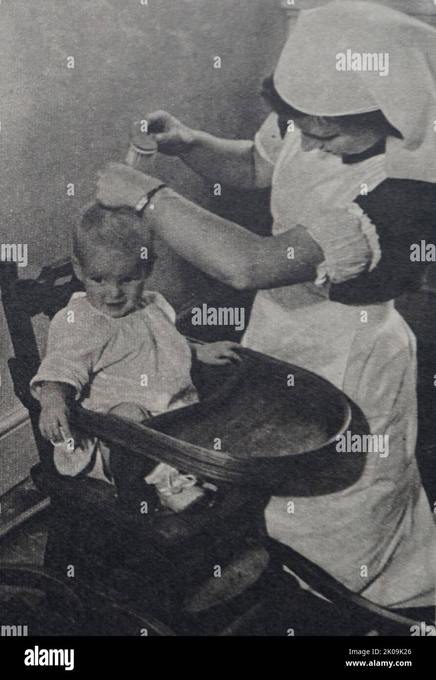 Seconda guerra mondiale, un bambino con la sua infermiera in Inghilterra, 1945. Foto Stock