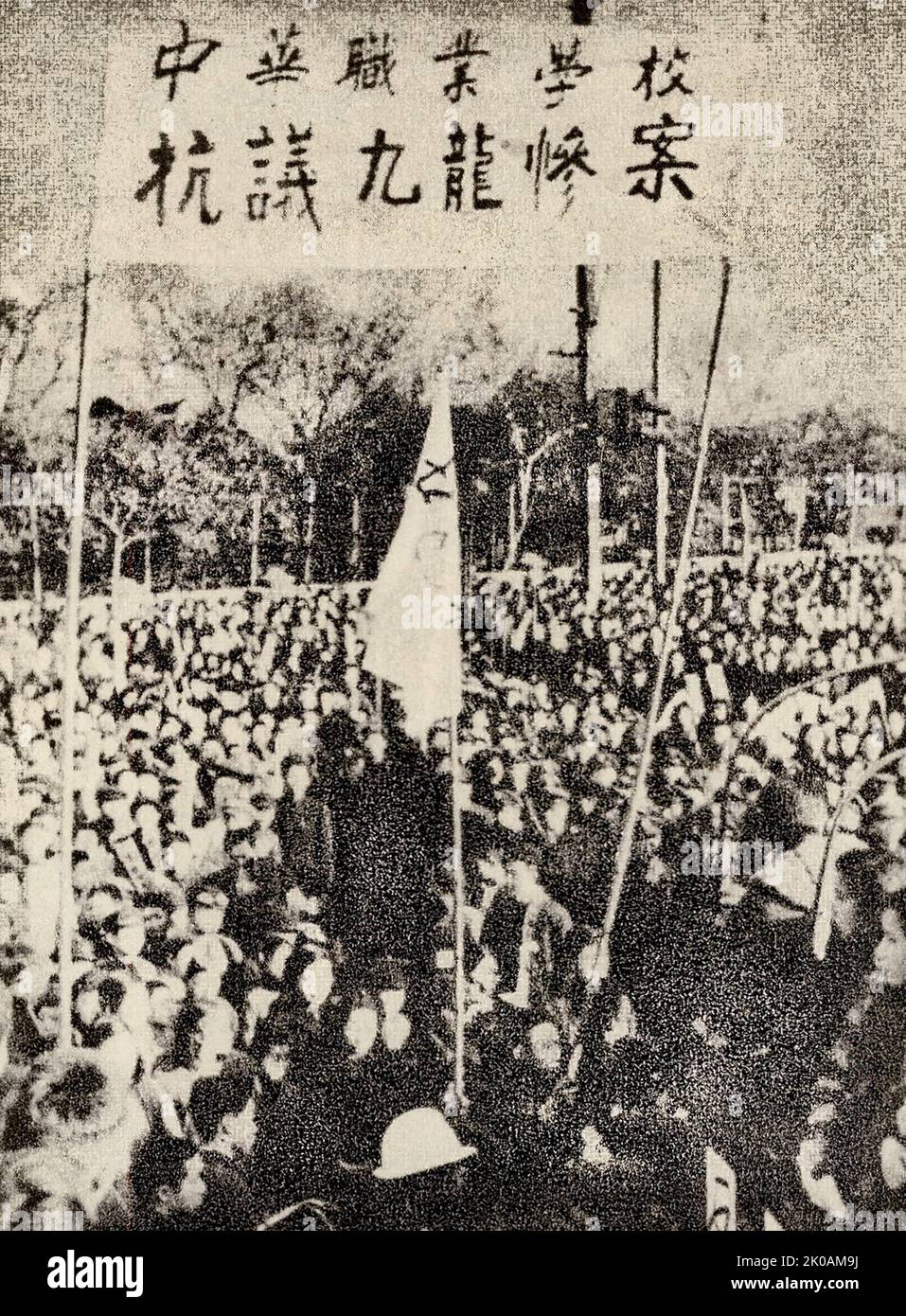 I manifestanti avanzano. Protestavano contro le autorità britanniche di Hong Kong che hanno demolito un gran numero di case e perseguitato i compatrioti di Kowloon per costruire l'aeroporto di Kowloon. Foto Stock