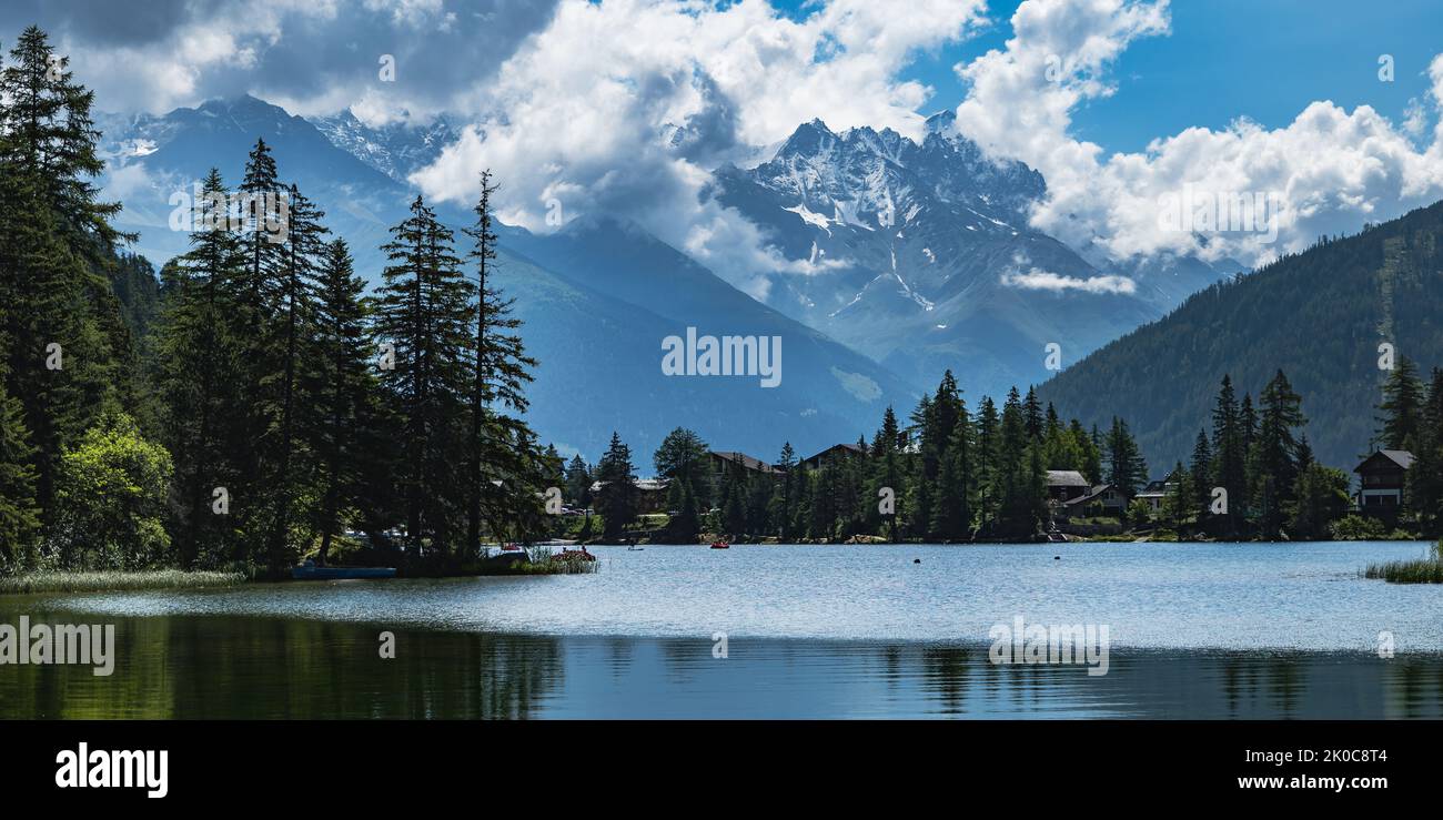 Vista sul lago Champex Lac e le cime montane in Svizzera, riflessi sull'acqua al mattino Foto Stock