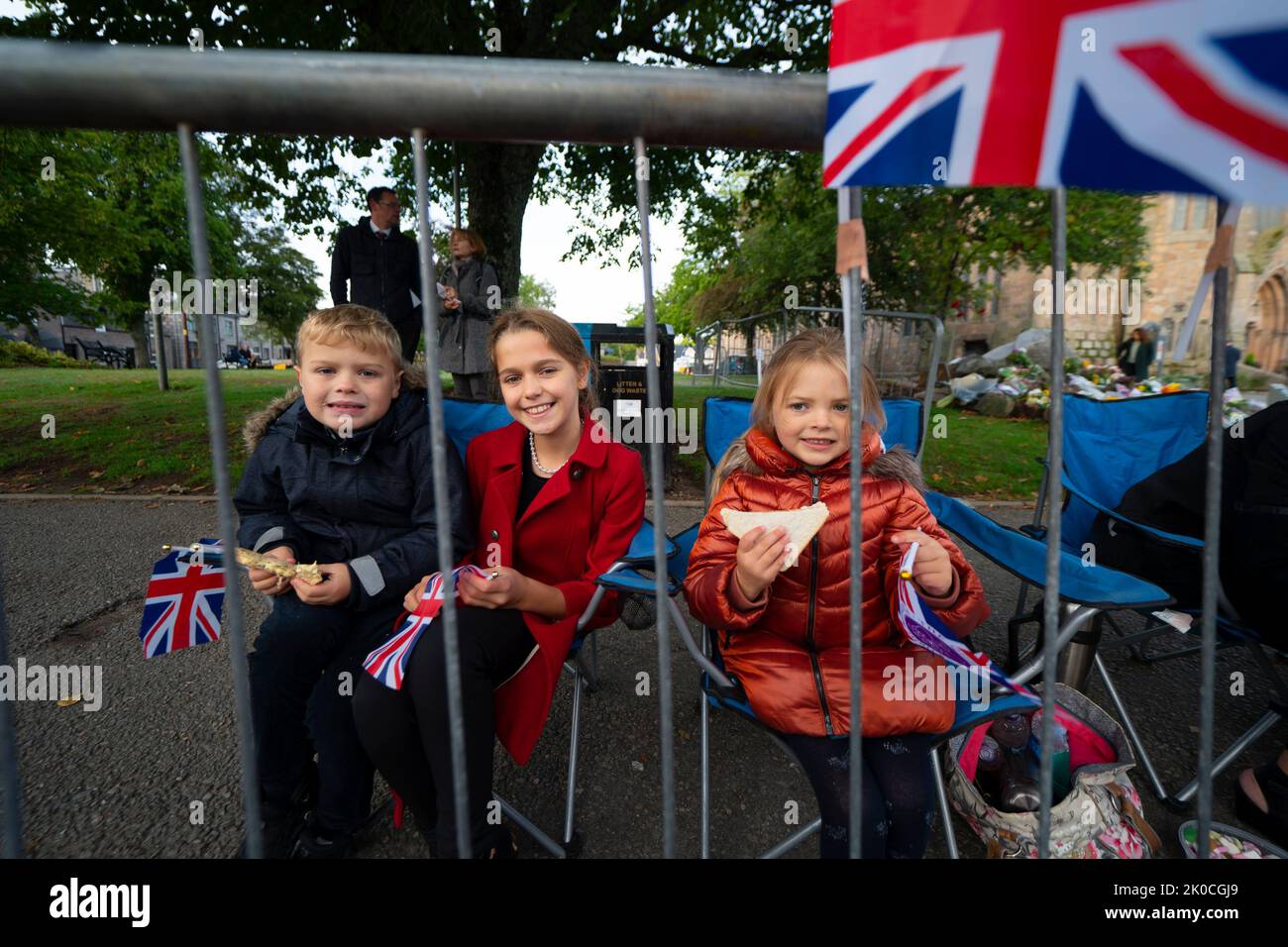 Ballater, Scozia, Regno Unito. 11th settembre 2022. I giovani membri del pubblico arrivano presto a Ballater 3 ore prima che il corteo sia dovuto passare. Hamish (8) Firenze (11) e (Gracie (5) sono scese da Huntly e hanno posti in prima fila. Ballater è un villaggio più vicino al castello di Balmoral ed è sulla strada del corteo che porta la bara della regina Elisabetta II a Edimburgo oggi. Iain Masterton/Alamy Live News Foto Stock