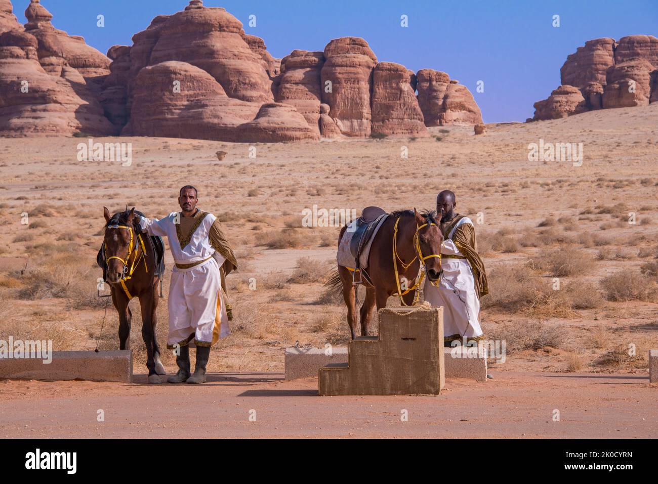Due gestori di cavalli in attesa di clienti turistici Hegra Arabia Saudita Foto Stock