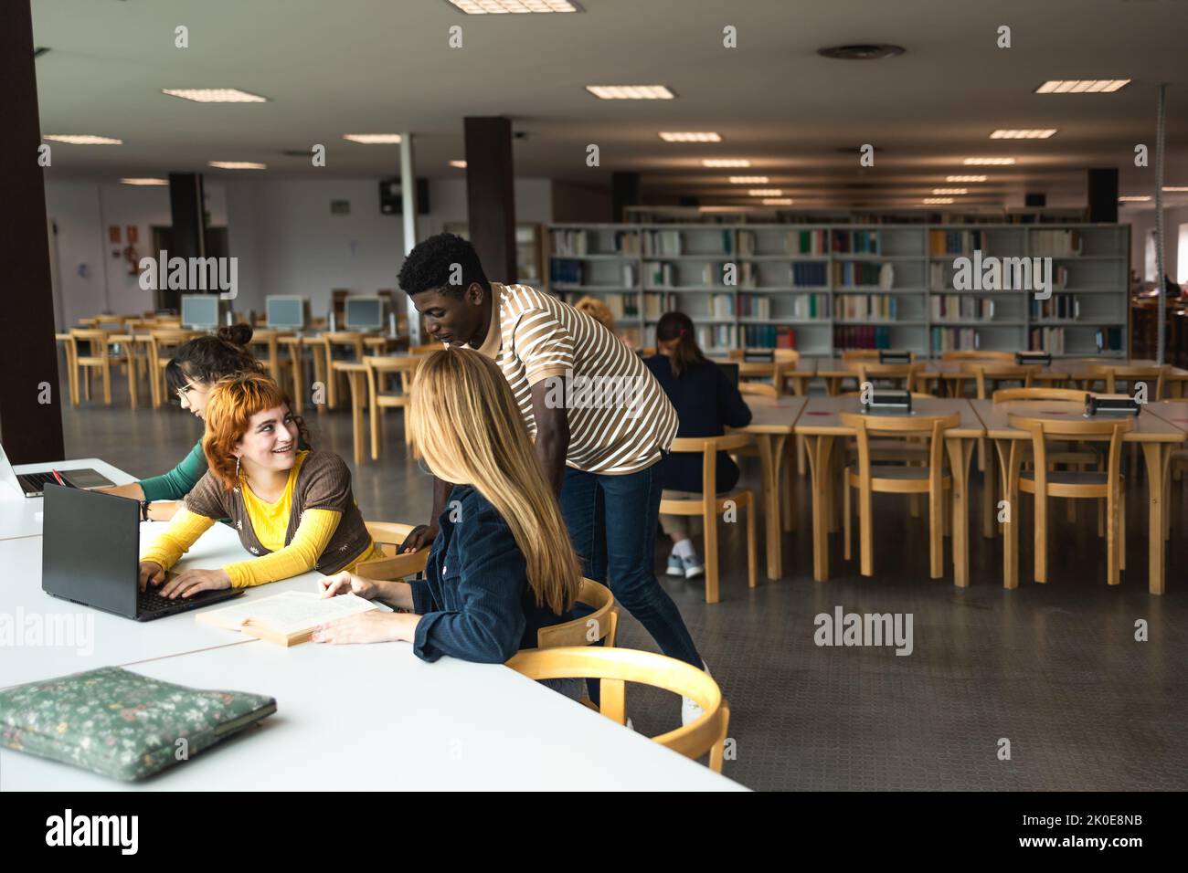 Giovani persone diverse che studiano in biblioteca - concetto di educazione scolastica Foto Stock
