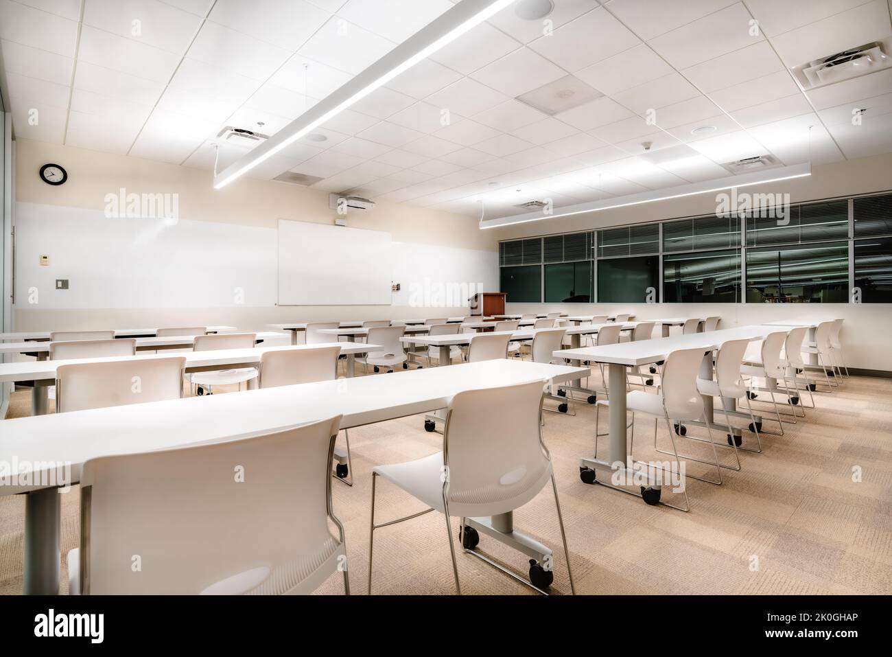 Esempio di una nuova formazione in ufficio vuota e non descrittiva, sala riunioni con scrivanie, sedie e lavagna bianca. La camera potrebbe trovarsi in quasi tutti gli uffici. Foto Stock