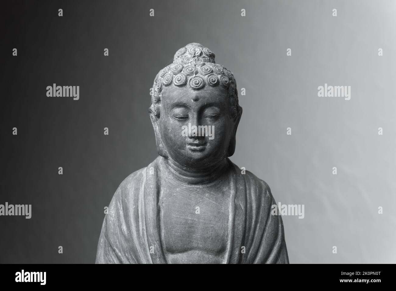 Statua di Siddharha Gautama Buddha fatta di pietra grigia come decorazione interna Foto Stock