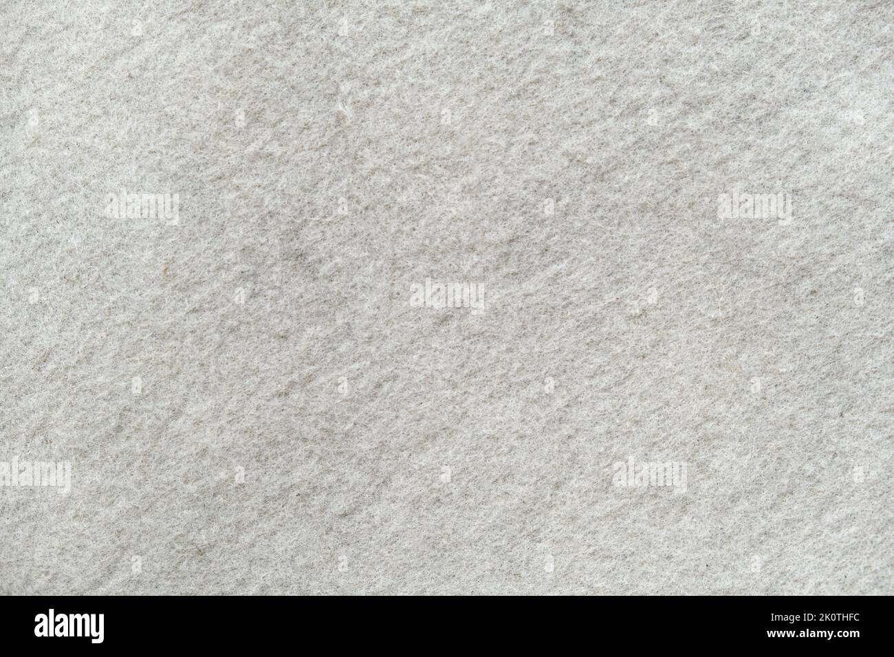 La texture del feltro bianco. Sfondo in feltro d'argento. Sembrava di neve. Foto Stock