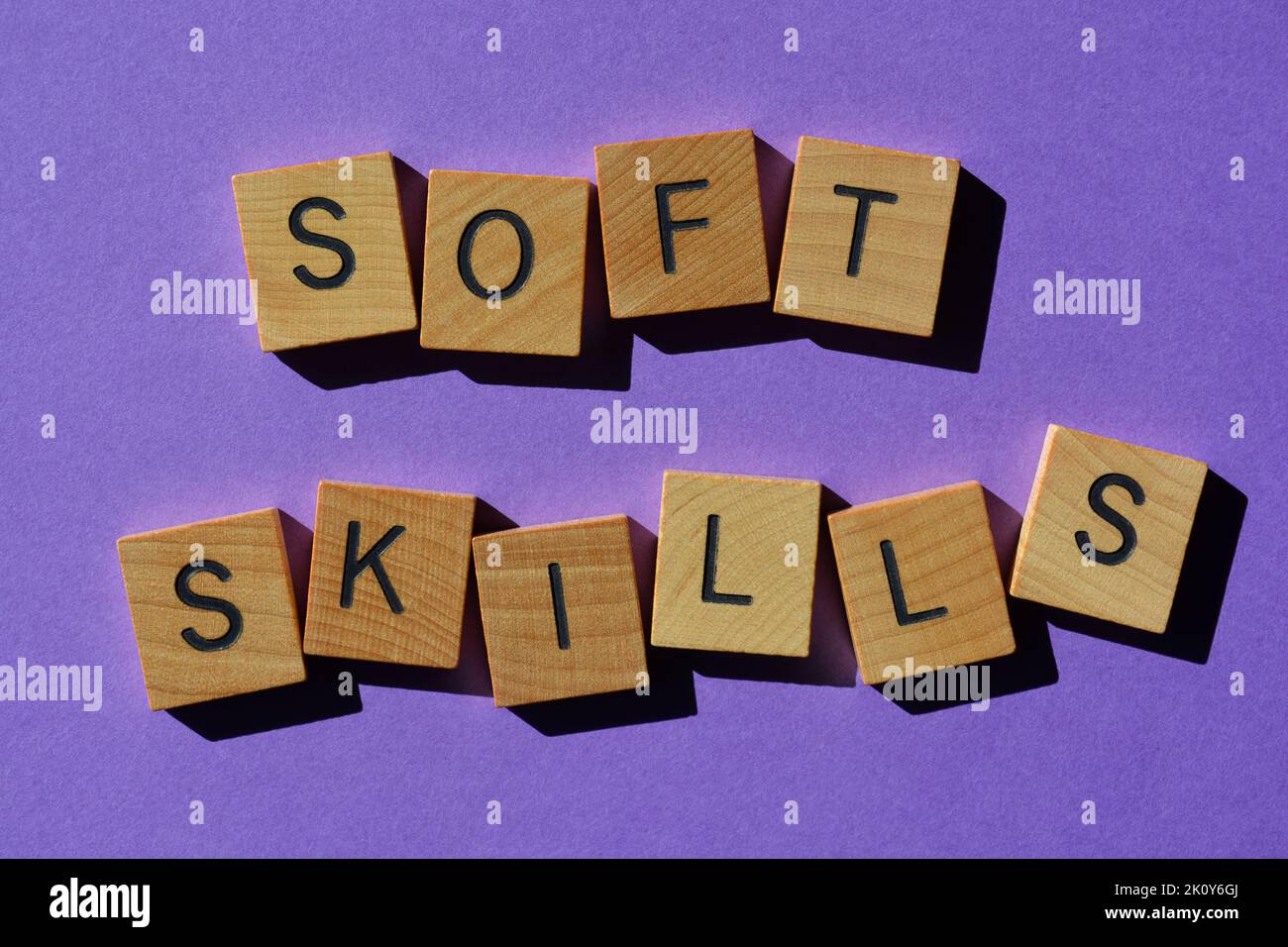 Abilità morbide, parole in lettere alfabetiche di legno isolate su sfondo viola Foto Stock