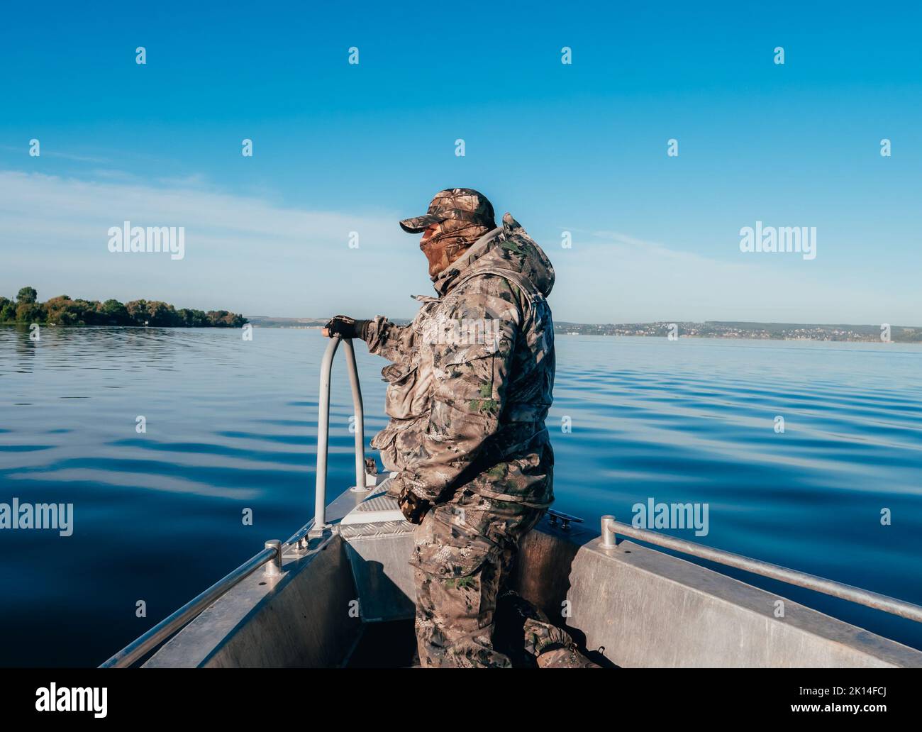 Tatarstan, Russia. Agosto 19, 2022. Poliziotto ambientale in un raid per apprehend bracconieri. Un uomo in mimetizzazione sulla prua di una barca. Foto Stock