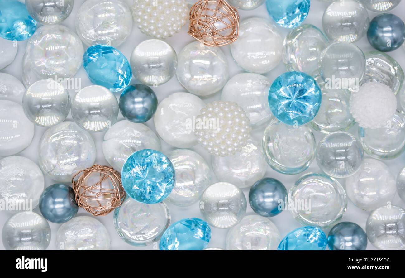 Bellissimo sfondo di perle di vetro blu chiaro, trasparenti e perle bianche. Spazio di copia. Foto Stock