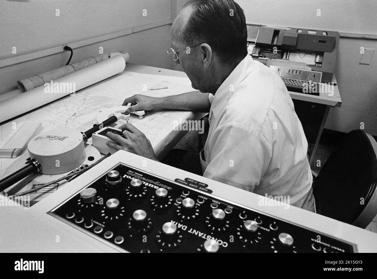 Creazione di mappe controllata da computer. Una macchina di disegno applica le elevazioni di contorno su una mappa recentemente sviluppata dello stato dell'Arizona. 1978. Foto Stock