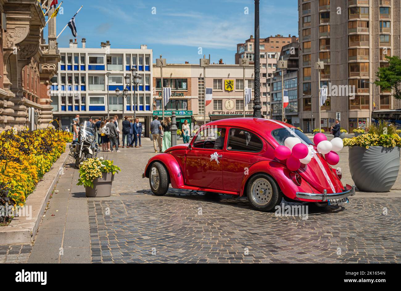 Europa, Francia, Dunkerque - 9 luglio 2022: Di fronte al municipio storico. Closep di storico rosa VW scarabeo auto con palloncini utilizzati da appena sposato cou Foto Stock
