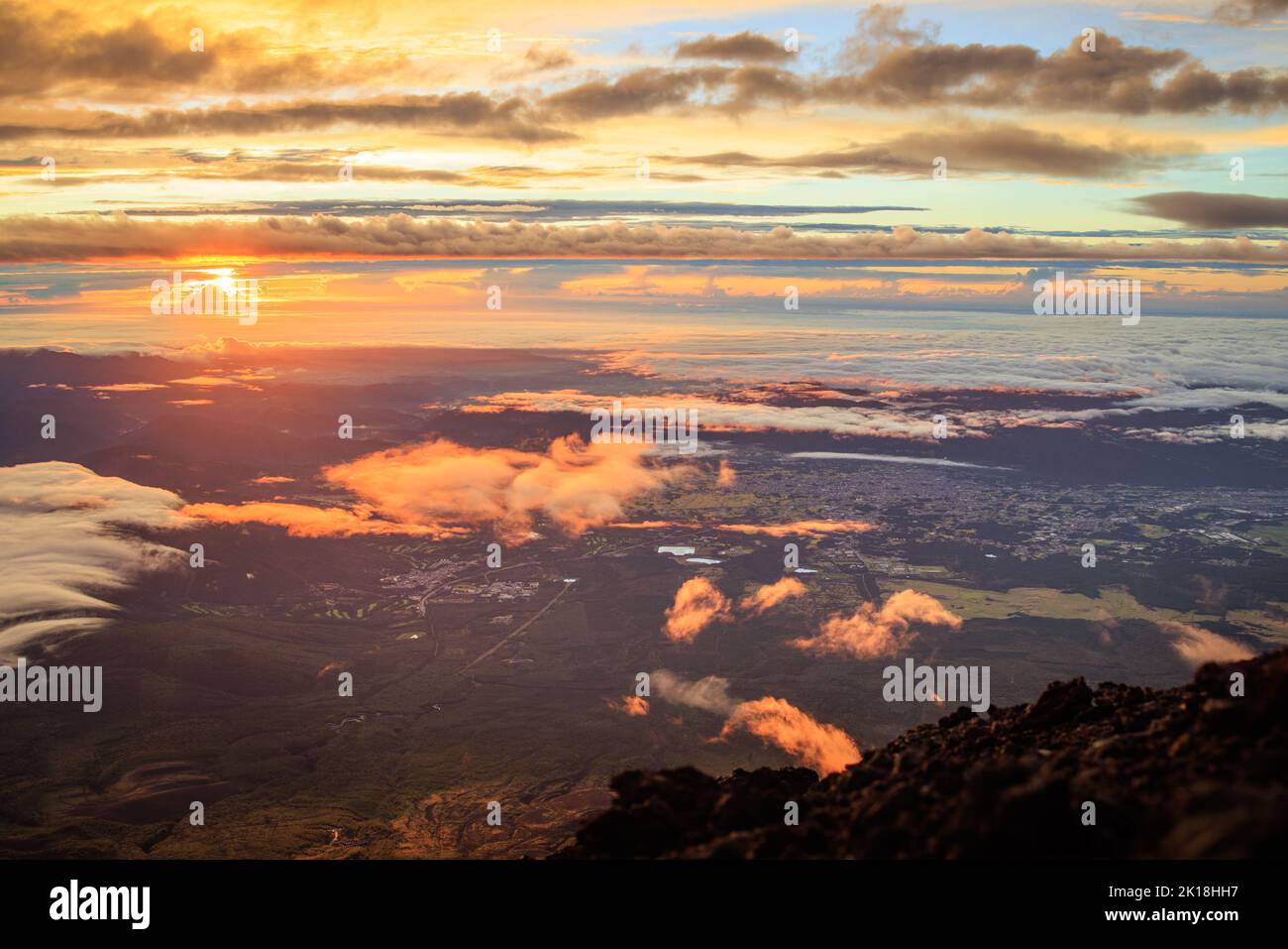 Il sole della mattina presto colpisce le nuvole vicino alla cima del monte Fuji Foto Stock
