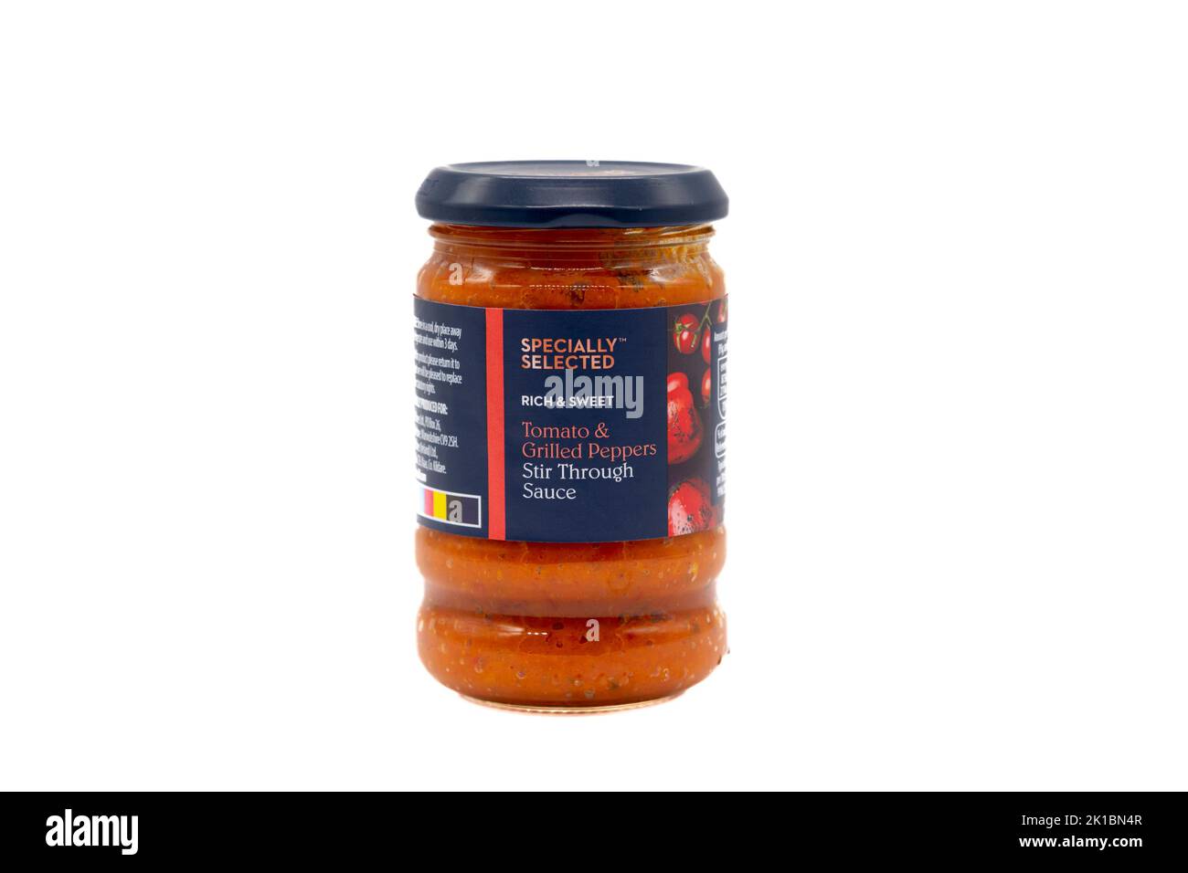 Irvine, Scozia, Regno Unito - 20 agosto 2022: Il pomodoro e i peperoni grigliati di marca Aldi si mescolano attraverso la salsa in un vaso di vetro riciclabile. Foto Stock