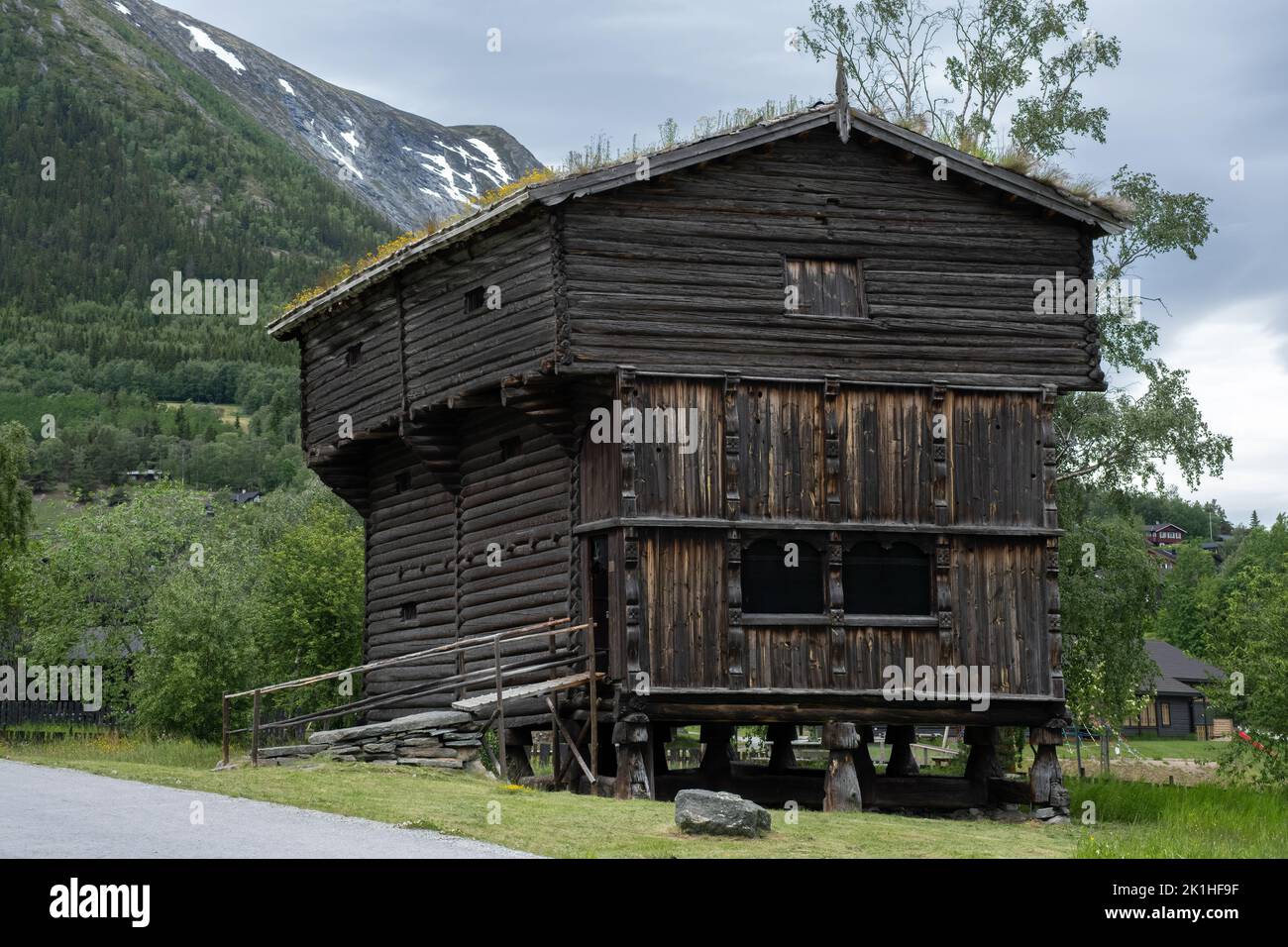 Paesaggi meravigliosi in Norvegia. Innlandet. Bellissimo scenario di case con tetto in erba. Architettura tradizionale norvegese. Montagne e alberi a bac Foto Stock