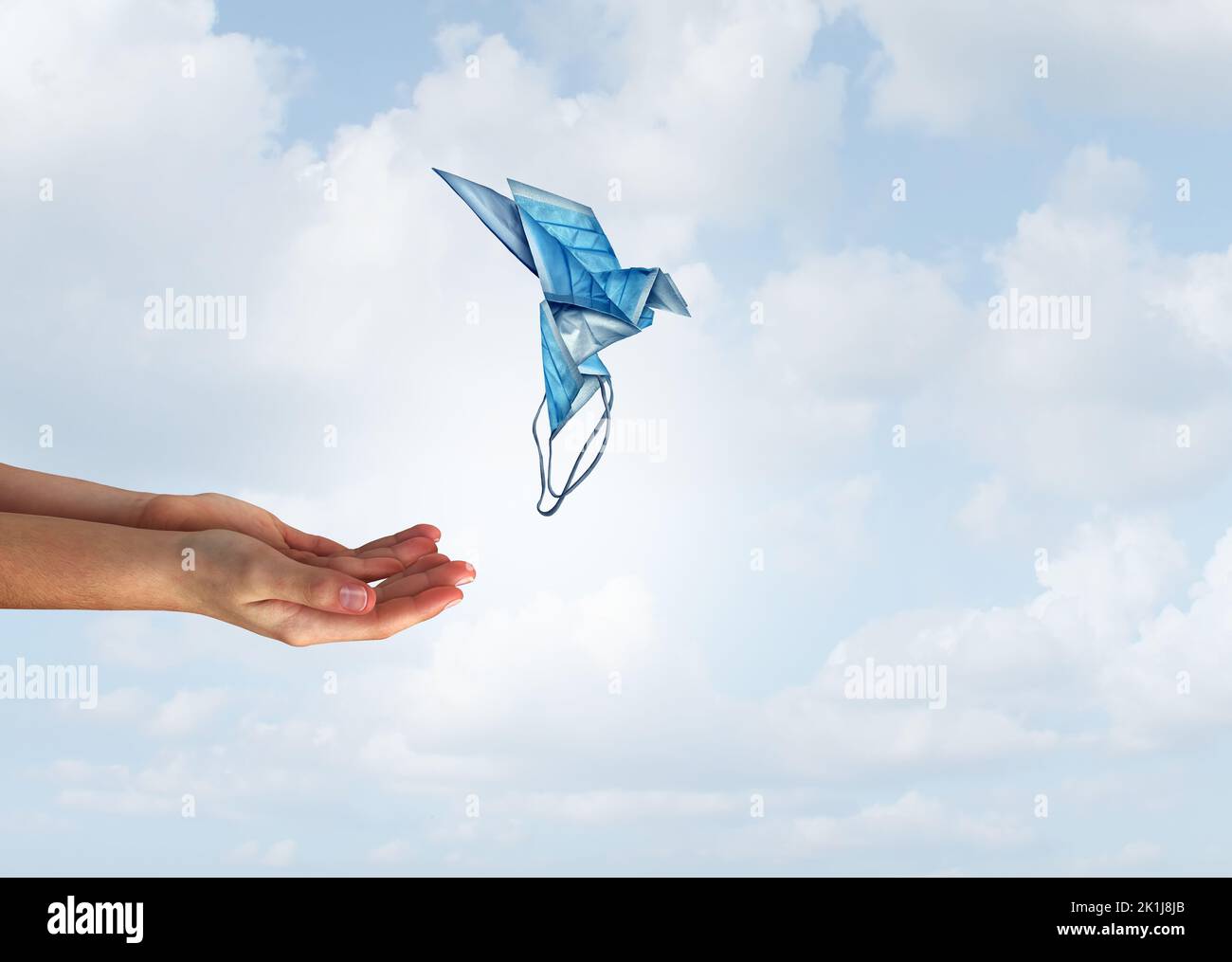 Concetto di speranza medica e la libertà come mani rilasciare una magica maschera volante a forma di uccello come un simbolo di salute per il successo della medicina. Foto Stock