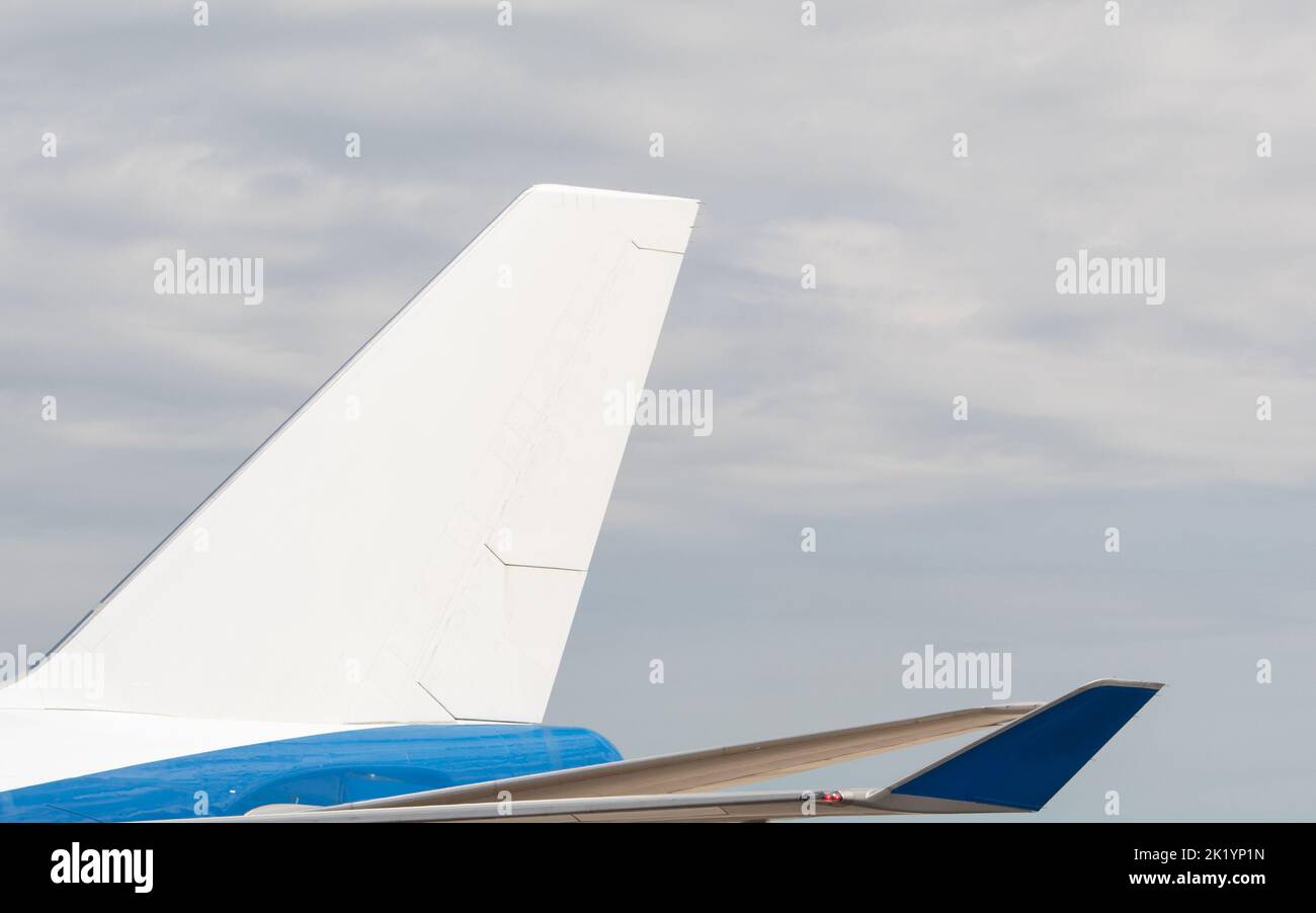 Una coda bianca vuota per un grande jumbo-jet blu, aereo di linea, visto in una giornata nuvolosa. Foto Stock