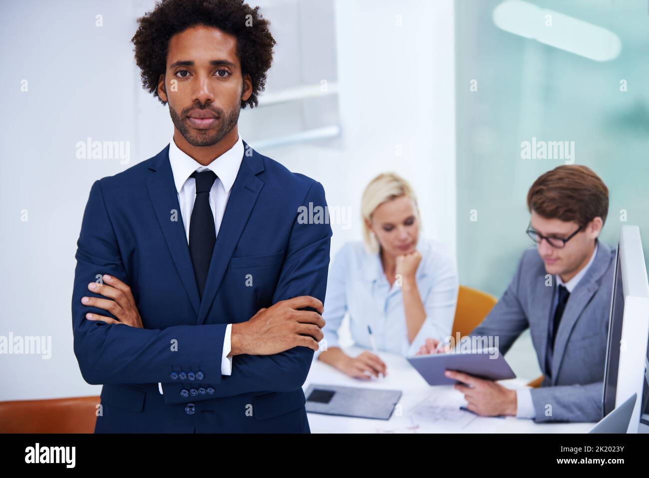 HES progetta un futuro solido. Ritratto di un serio uomo d'affari con colleghi sullo sfondo. Foto Stock