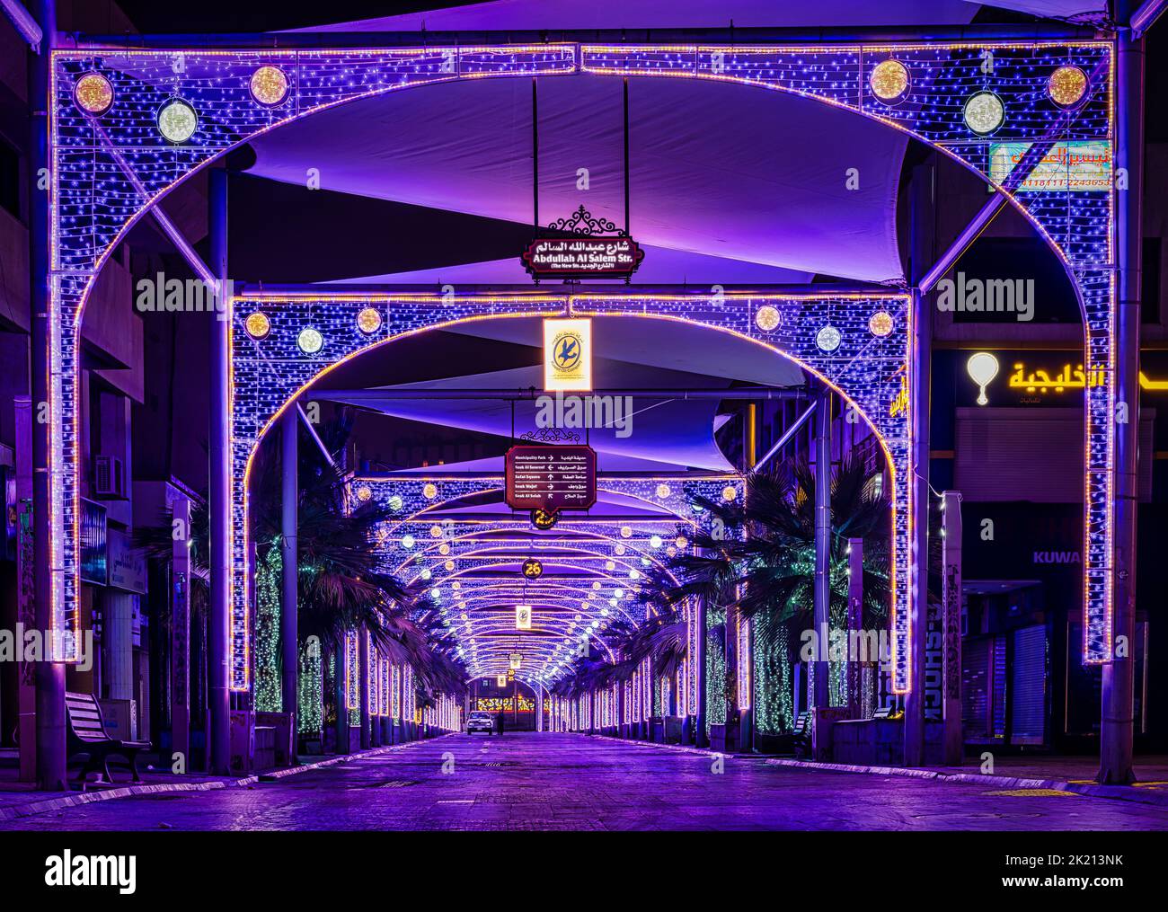 Una bella foto del mercato cittadino del Kuwait durante la notte decorata con luminose luci viola al neon Foto Stock