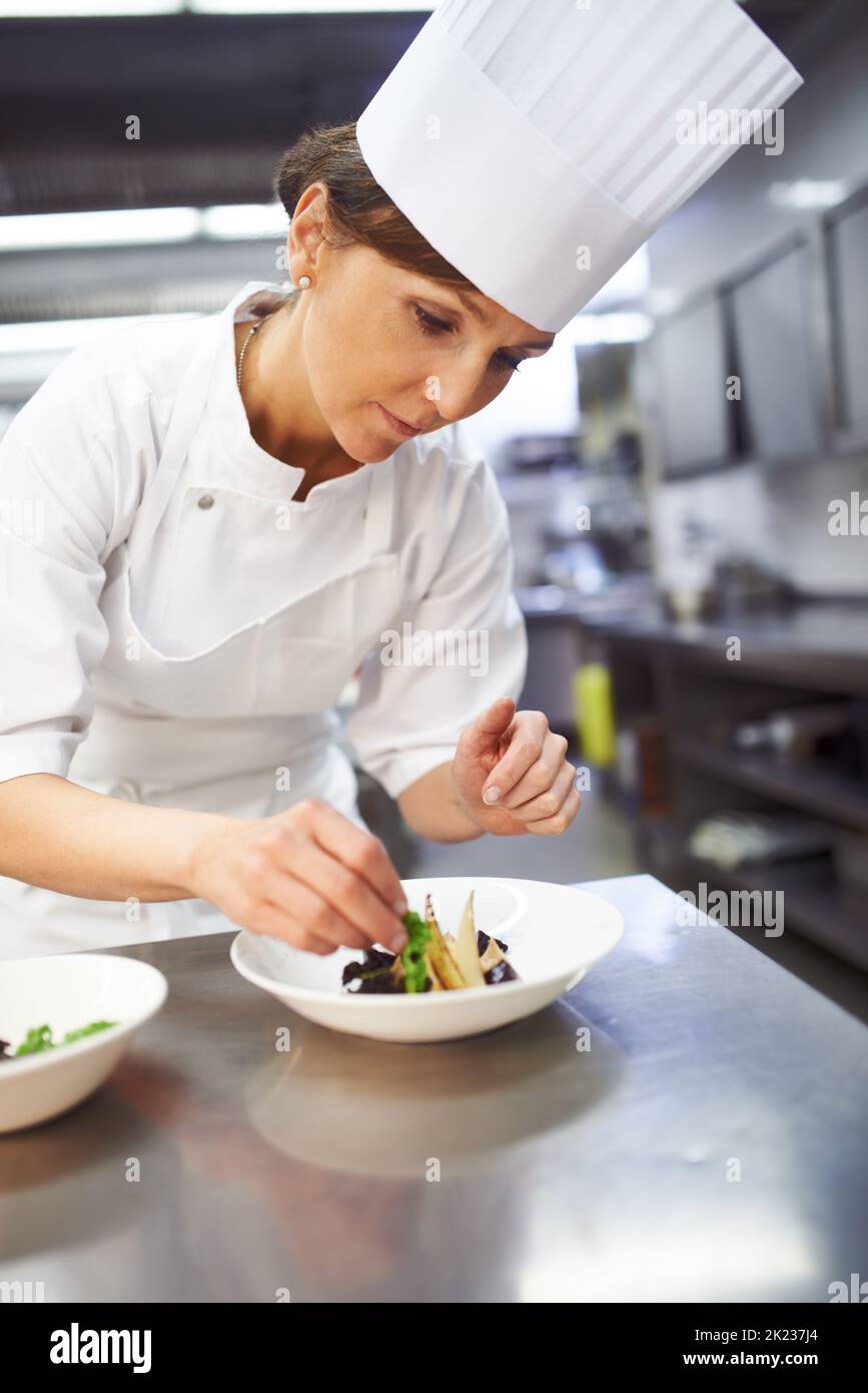 Cuoco un maestro al piatto. Uno chef prepara dessert in una cucina professionale. Foto Stock