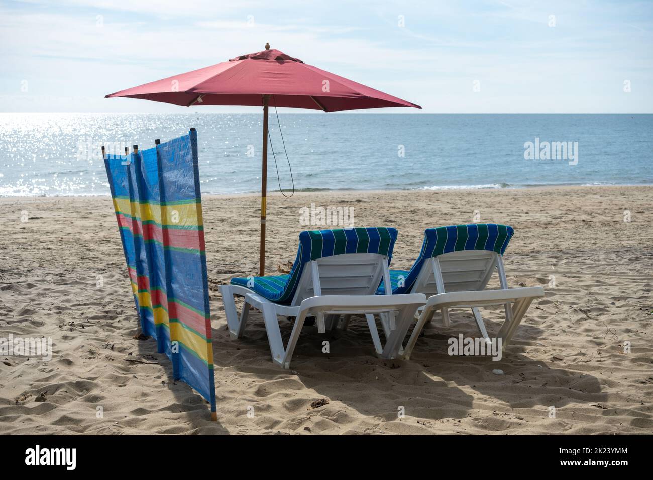Possibilità di rilassarsi in spiaggia, lettini con scudo antivento e ombrellone. Non c'è nessuno che apra l'oceano e una spiaggia vuota. Foto Stock