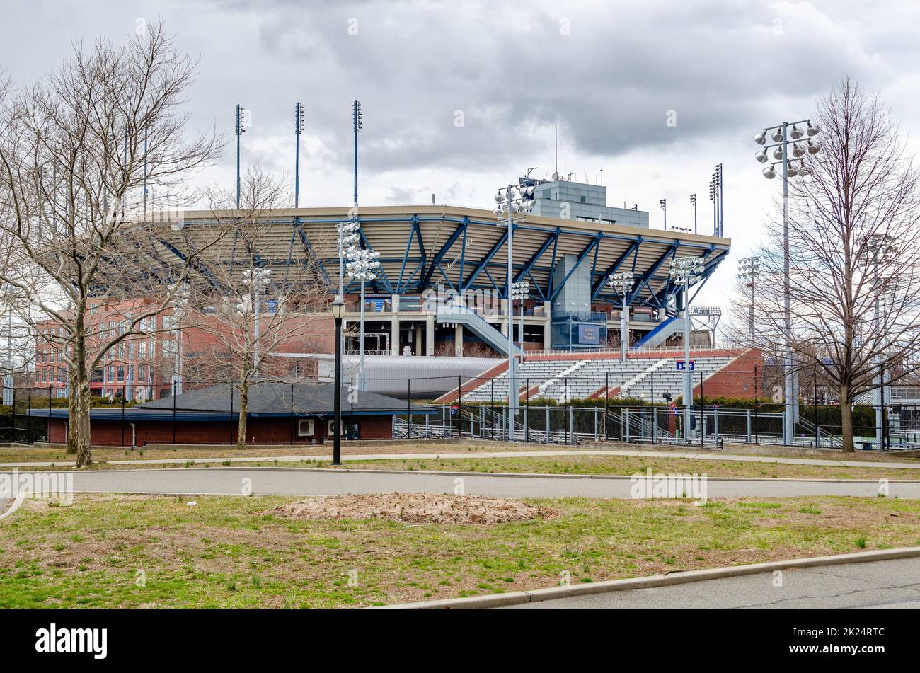 Arthur Ashe Stadion, Queens vista laterale con strada e prato di fronte, New York City durante la giornata invernale sovrastata, orizzontale Foto Stock