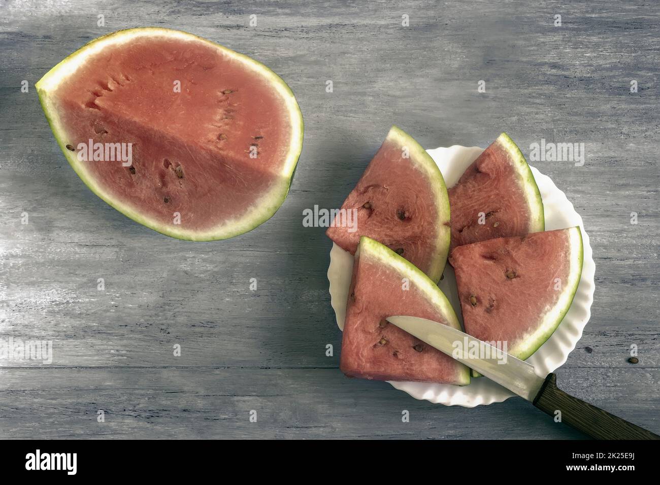 Cocomero tagliato a fette su un tavolo di legno Foto Stock