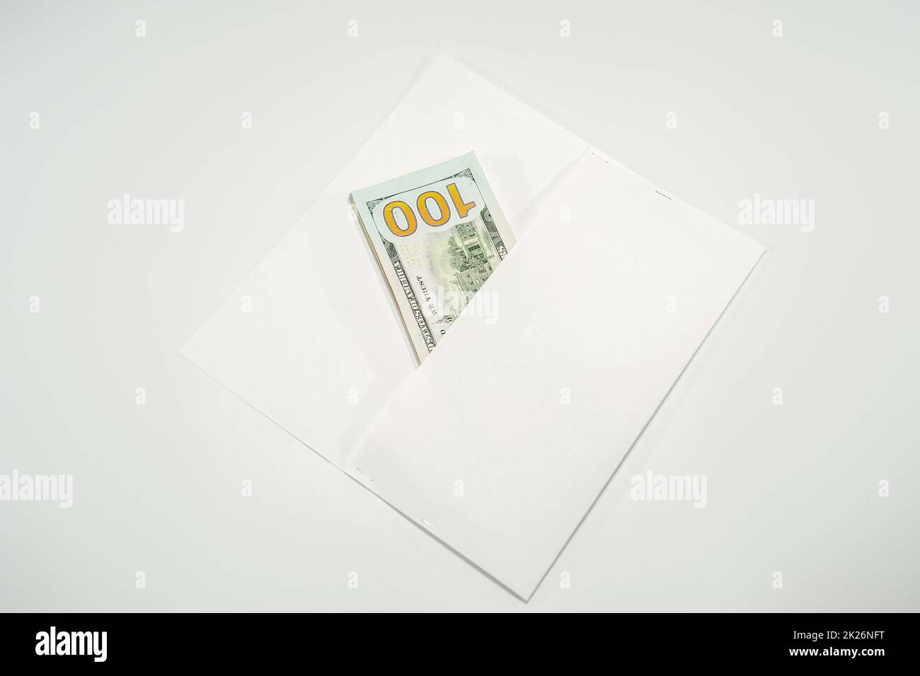 Dollari in un conwind su sfondo bianco, un sacco di soldi in una busta. Foto Stock