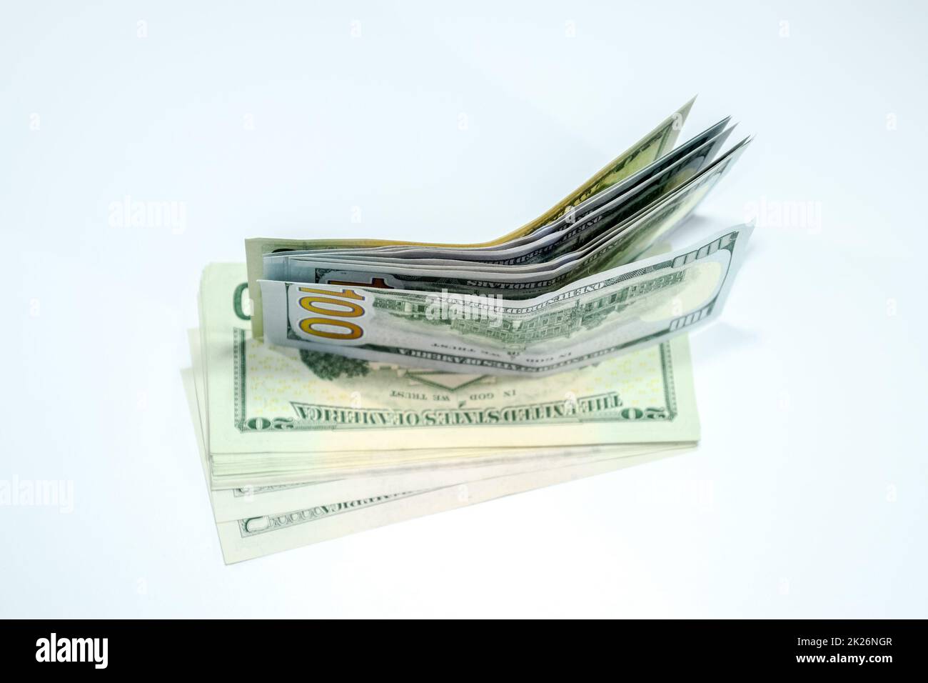 Dollari in un conwind su sfondo bianco, un sacco di soldi in una busta. Foto Stock