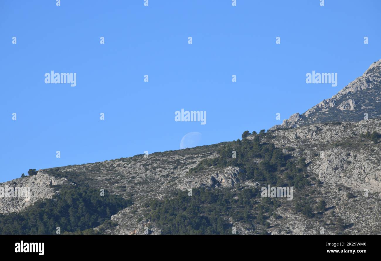 La luna, poco prima di scontrarsi con la montagna, provincia di Alicante, Costa Blanca, Spagna Foto Stock