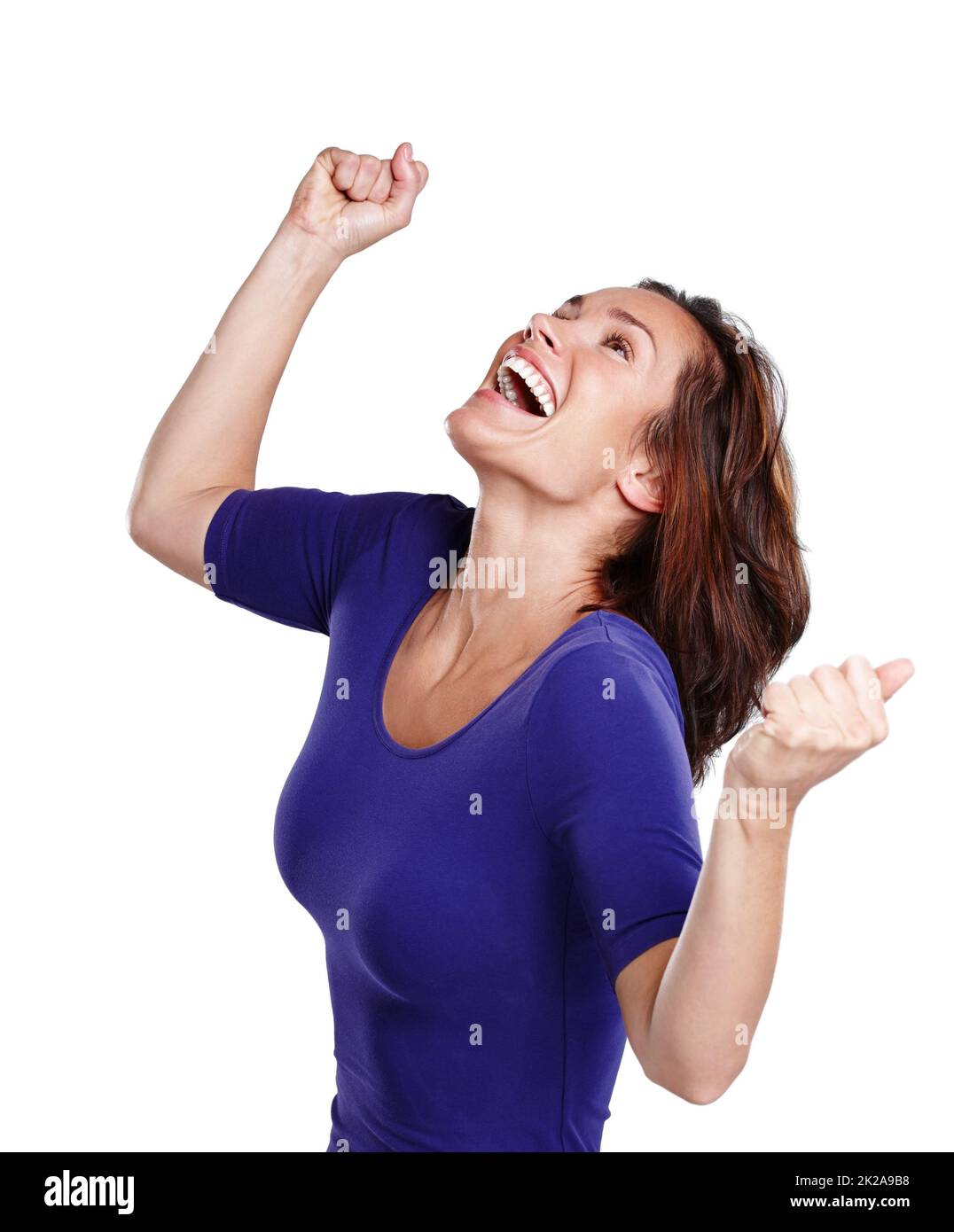 La vittoria è mia. Una giovane donna in casual vestito punzonando l'aria in festa. Foto Stock