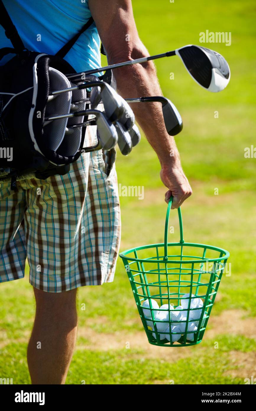 Venite sempre preparati. Immagine ritagliata di un golfer che trasporta un secchio delle sfere. Foto Stock