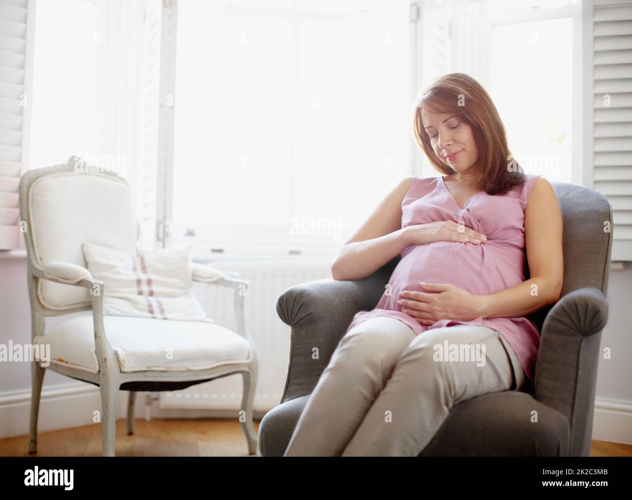 La maternità è una cosa meravigliosa. Una donna incinta incandescente che guarda il suo rigonfiamento del bambino con amore - CopySpace. Foto Stock