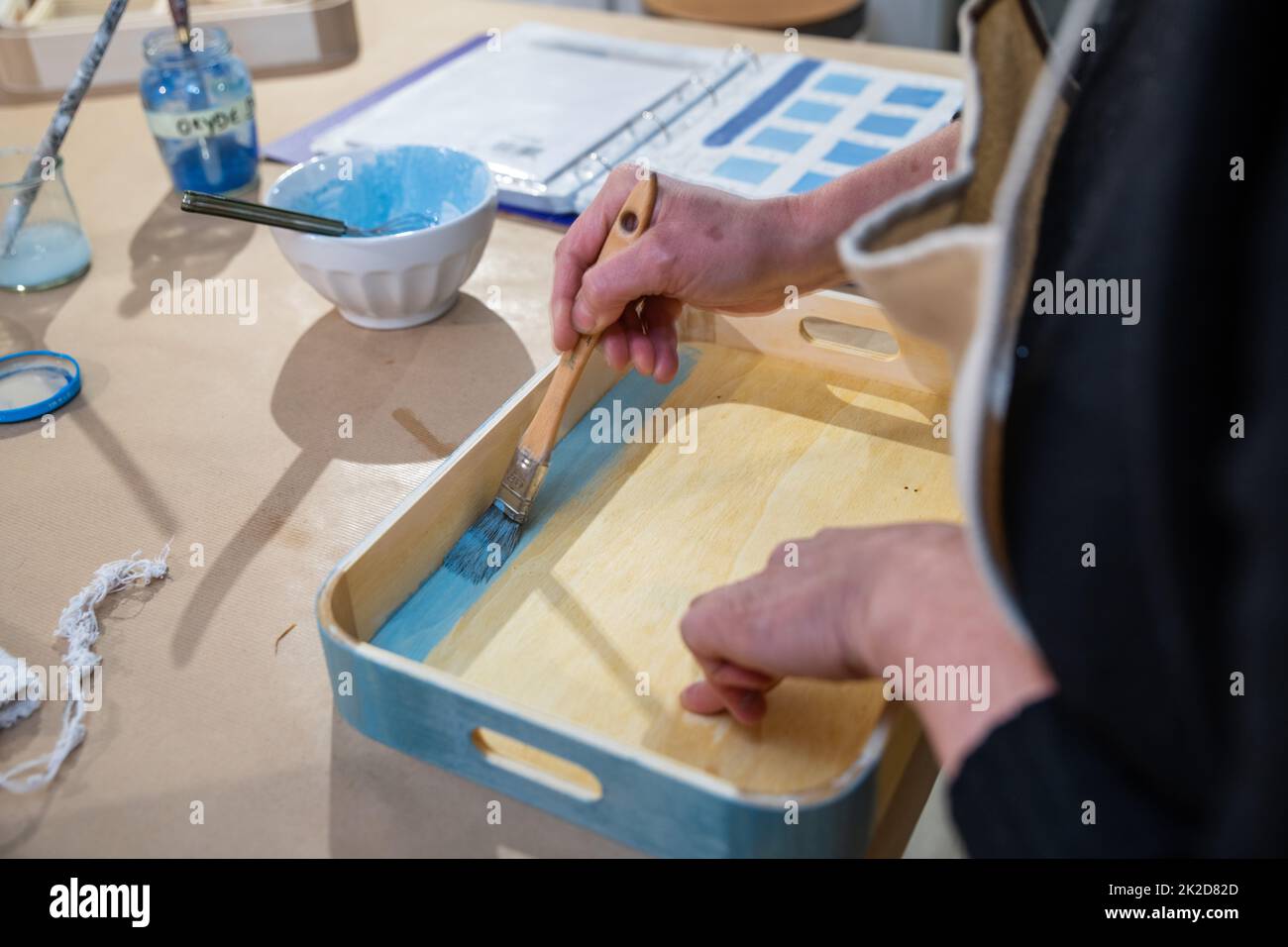 VERNICIATURA E DECORAZIONE DI UN VASSOIO FATTO A MANO Foto Stock