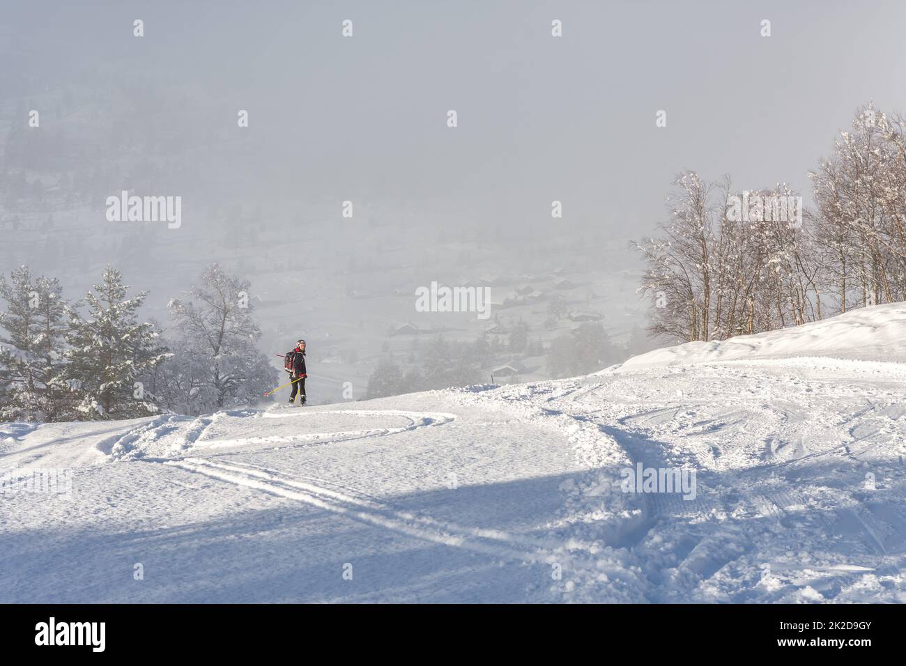 Donna con abbigliamento da sci nero che sciava giù per una montagna in norvegia Foto Stock