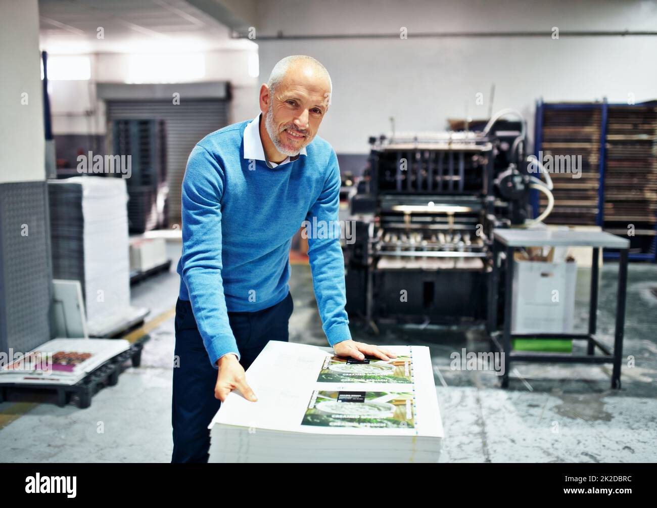 Il prodotto è la mia reputazione. Ritratto di un uomo che controlla la qualità di una stampa eseguita in fabbrica. Foto Stock
