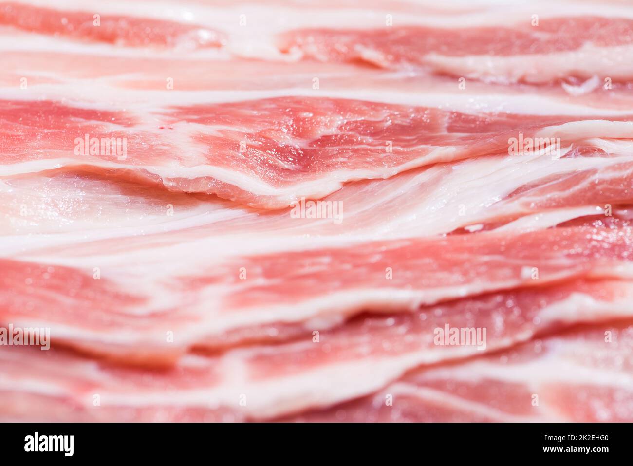 Confezione di primo piano fette fresche di pancetta di maiale Foto Stock