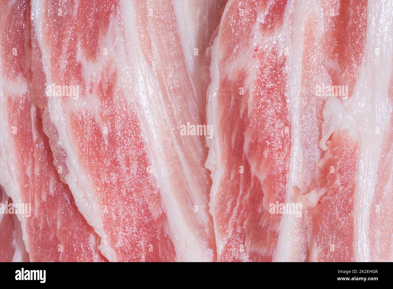 Confezione di primo piano fette fresche di pancetta di maiale Foto Stock