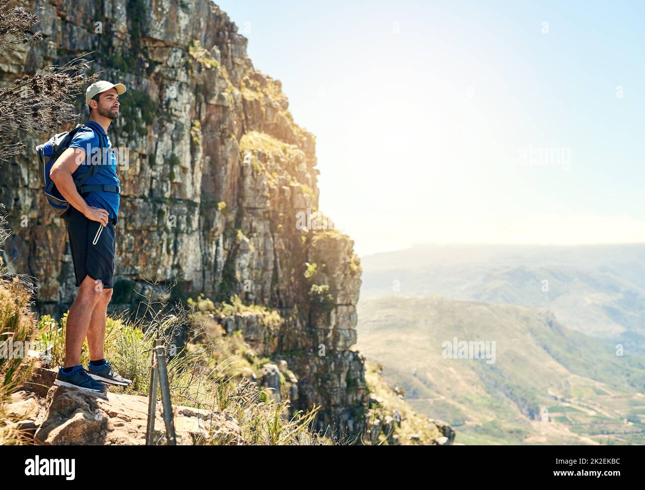 Ammirando la bellezza naturale del mondo. Scatto di un giovane che ammirava la vista dalla cima di una montagna. Foto Stock