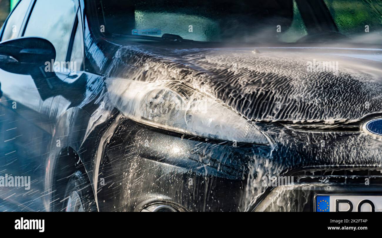 Un veicolo in un autolavaggio a gettoni Foto Stock