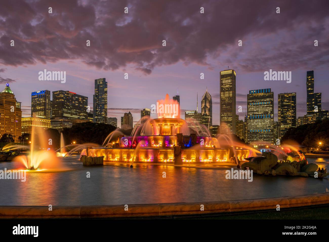 Spettacolo di luci colorate alla Buckingham Fountain con lo skyline della città sullo sfondo, Chicago, Illinois, USA Foto Stock