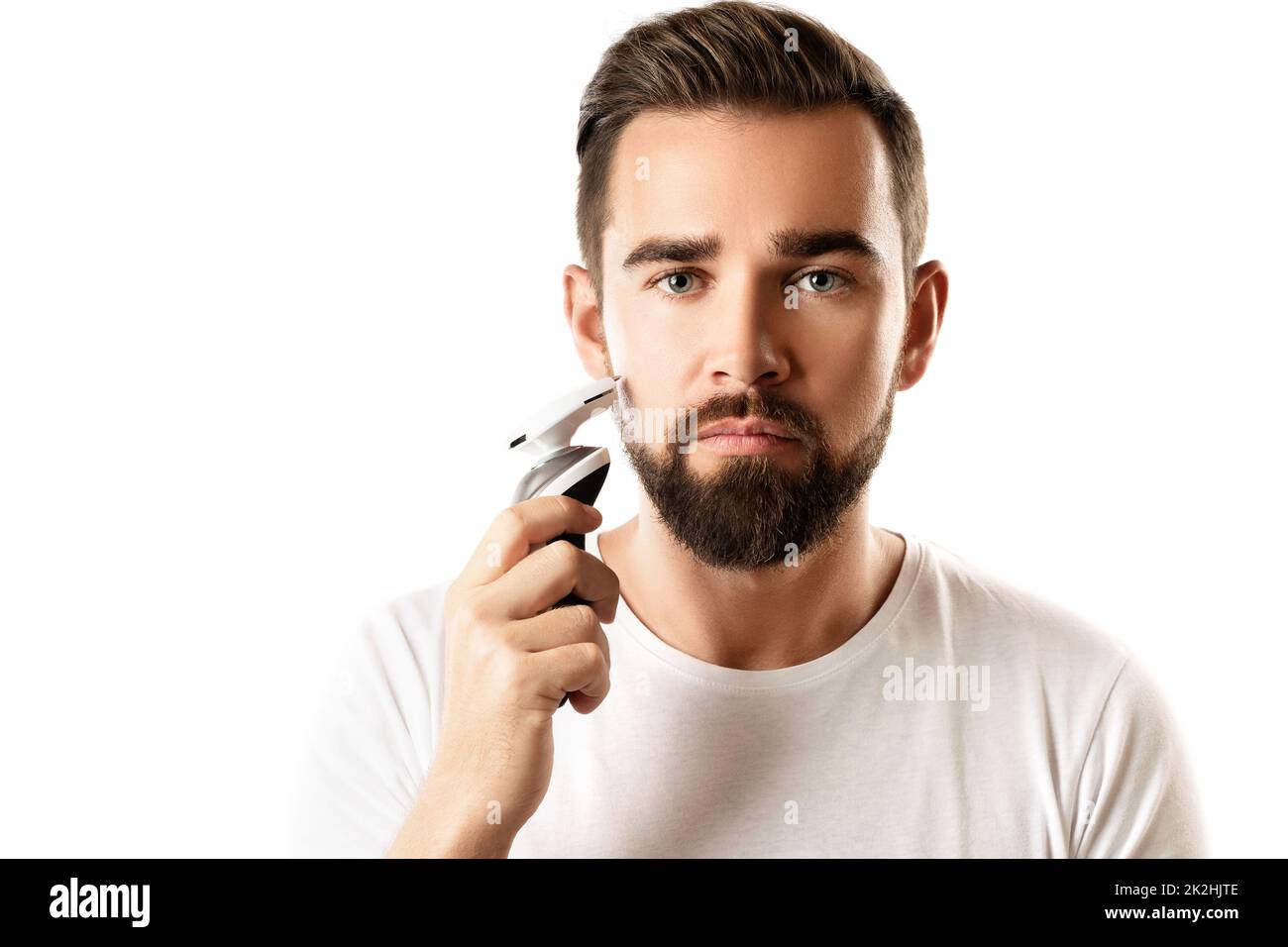 Bell'uomo bearded sta usando il tagliabasette elettrico Foto Stock