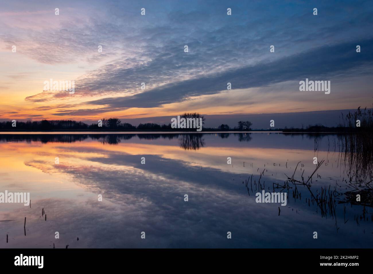 Riflesso speculare delle nuvole serali nel lago Foto Stock