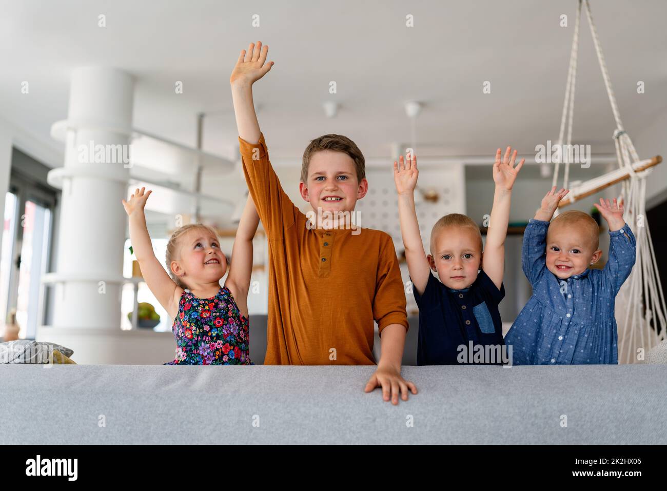 Gruppo di bambini che si divertono e sorridono insieme in interni. Foto Stock